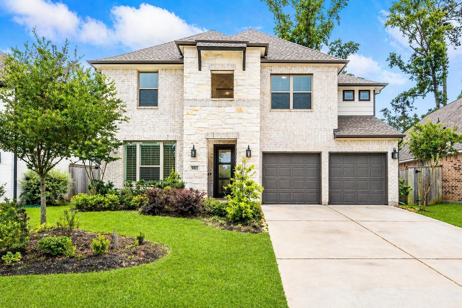 Two-story stone-and-brick Houston home with a landscaped front yard and two-car garage, illustrating a smart Houston home pricing strategy.