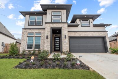 Modern smart home in Fulshear TX with video doorbell smart thermostat security cameras and full automation at 30155 Gold Finch Place.
