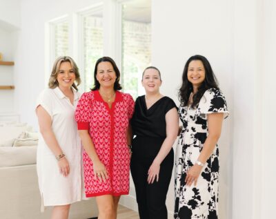 The Jamie McMartin Group, a Houston real estate team, gathered outside a Katy listing