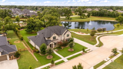 Aerial view of a Houston-area suburban neighborhood with tree-lined streets