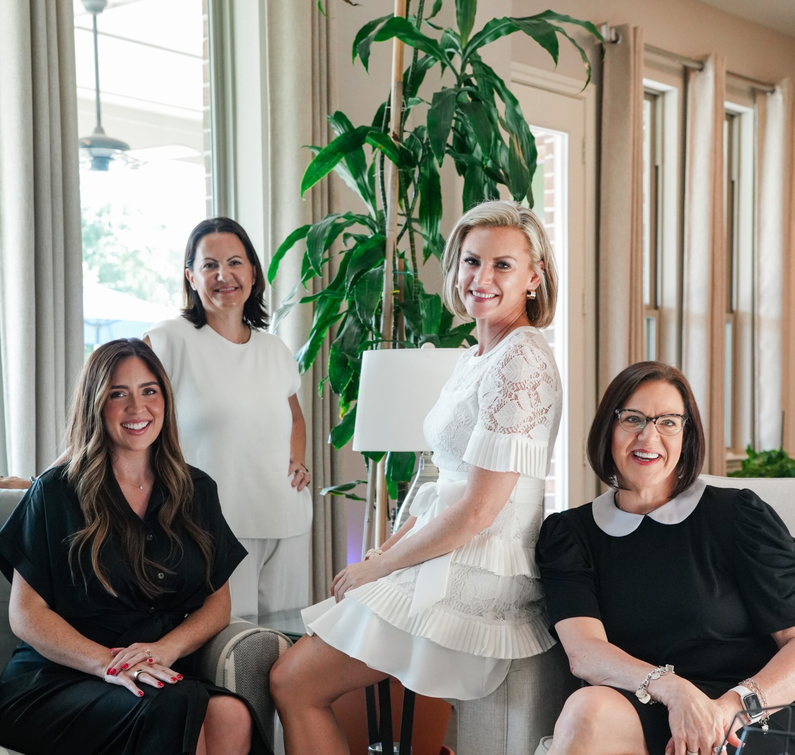 "Four women from The Jamie McMartin Group real estate team smiling together in a bright living room" A couple of things that would help me tailor this better: Is this going into a specific post (e.g., the "choosing a Houston Realtor" or reviews/reputation post), or is it for a general team/about page? I can adjust the caption to tie into that post's keyphrase and flow. Do you know the names of who's pictured? If so, I can write a more specific caption (e.g., "Jamie McMartin with [names], The Jamie McMartin Group") instead of the generic team reference.