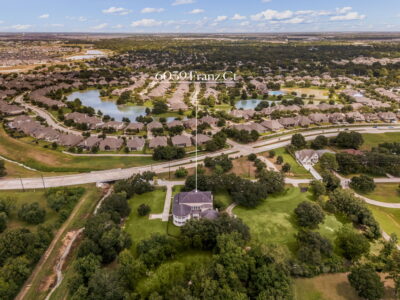 A row of homes for sale in a Houston suburb like Katy or Cypress, with a "For Sale" sign in the foreground