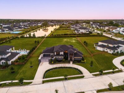 An aerial view of 29419 Circle S Ranch Trail shows the home's premium homesite backing to the lake, set among the established landscaping of Fulshear Run.
