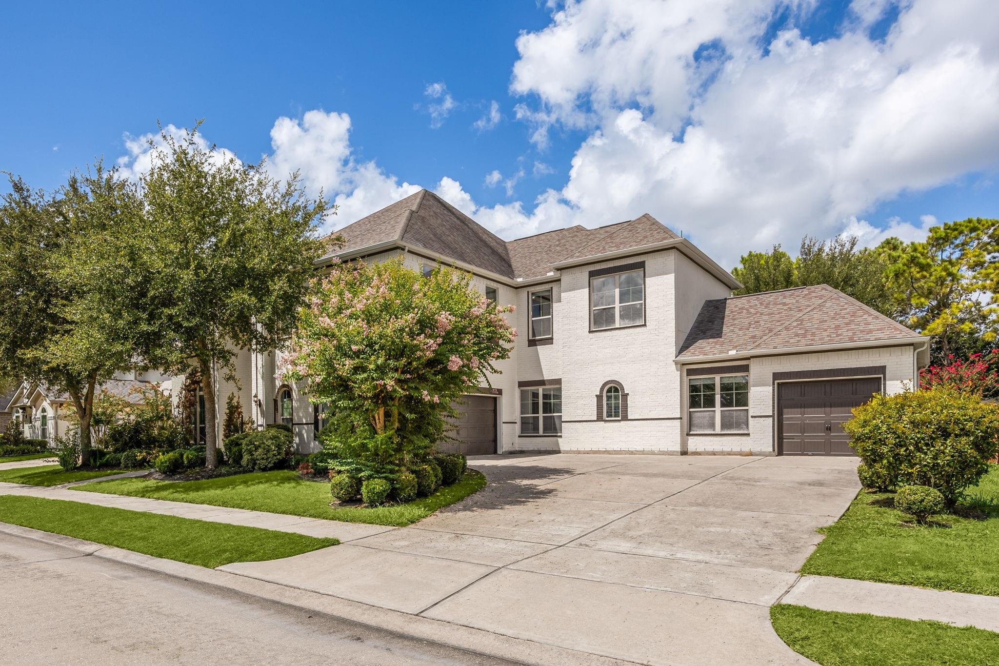 Home for sale in Aliana featuring two primary suites, mature landscaping, and a welcoming exterior near shopping and area schools.