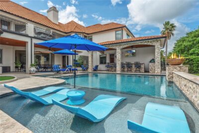 Resort-style pool and outdoor summer kitchen in a Houston luxury backyard renovation