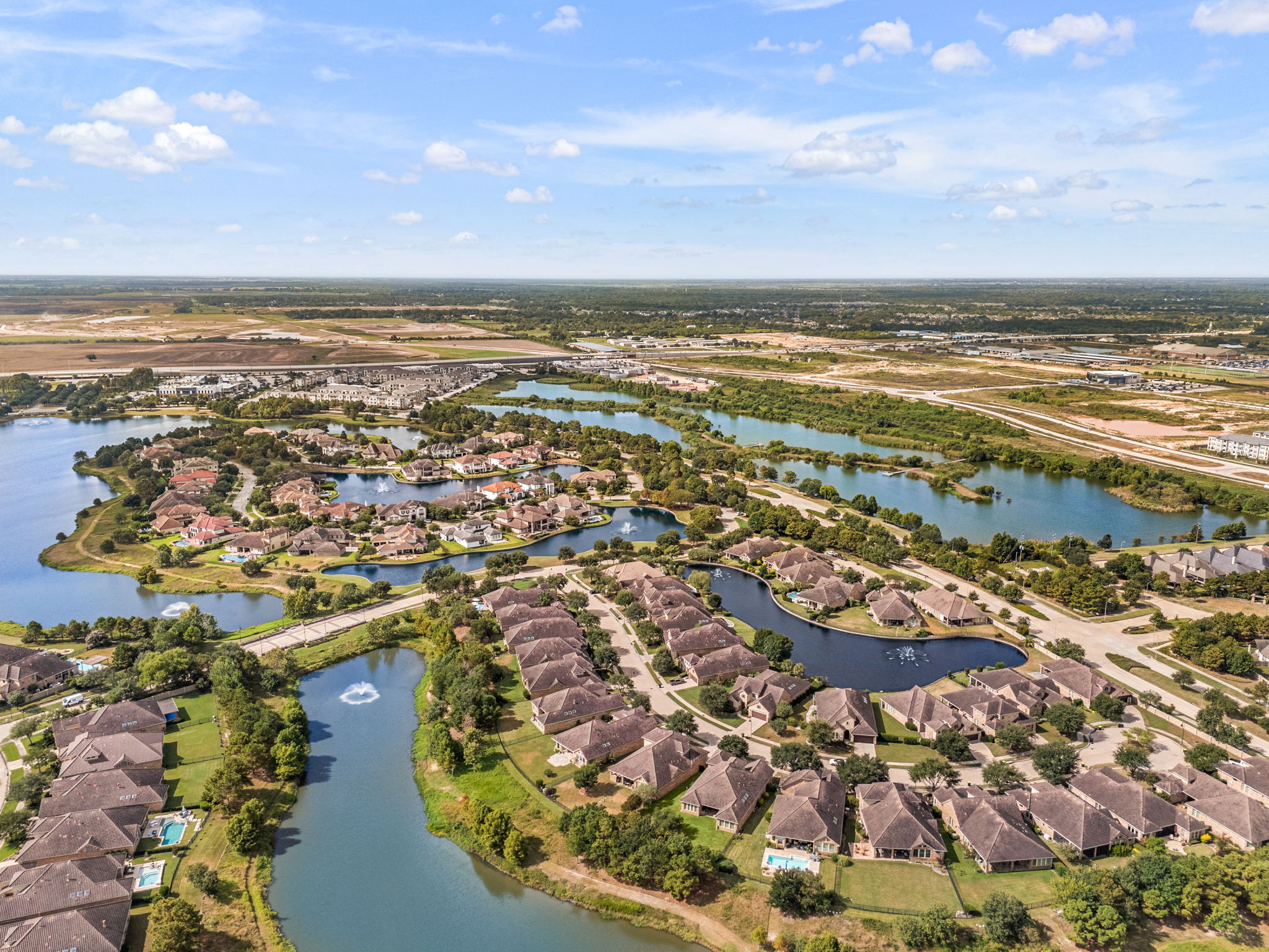 An aerial view of a Katy-area master-planned community with lakes and tree-lined streets, the kind of neighborhood detail a local Realtor in Katy tracks closely.