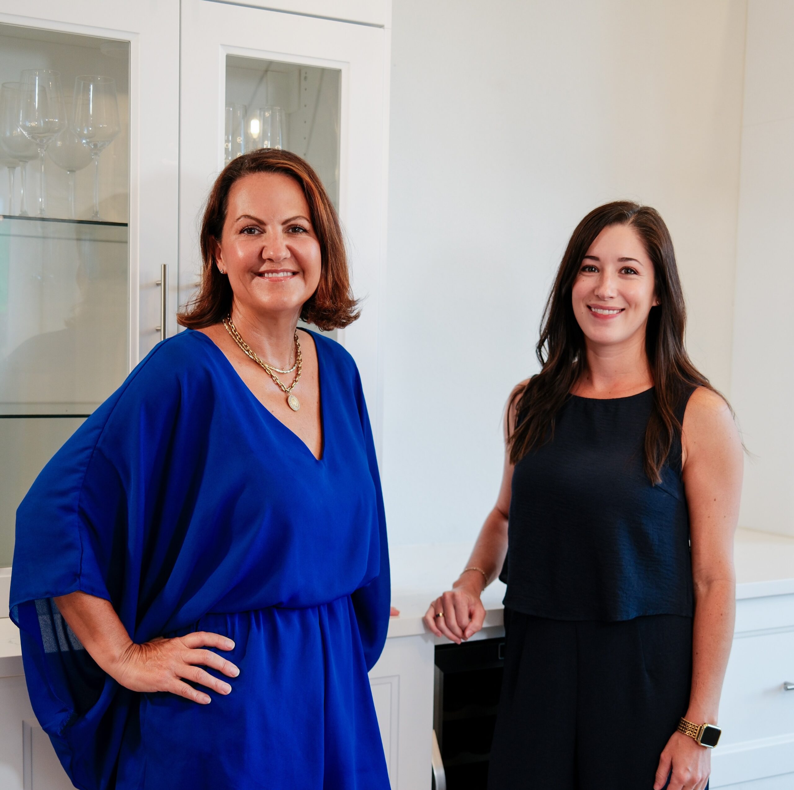 Two Jamie McMartin Group real estate agents smiling in a Houston-area home, representing the local team that helps newcomers relocating to Houston choose the right suburb.