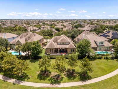 A local Realtor in Katy walking a client through a Cinco Ranch neighborhood