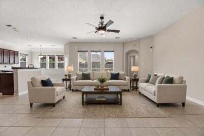 An open-concept family room flowing into a bright kitchen, the kind of easy layout many buyers look for when downsizing in Katy or Fulshear.