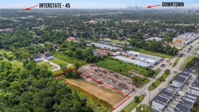 Houston skyline behind a residential neighborhood, part of this Houston housing market update.