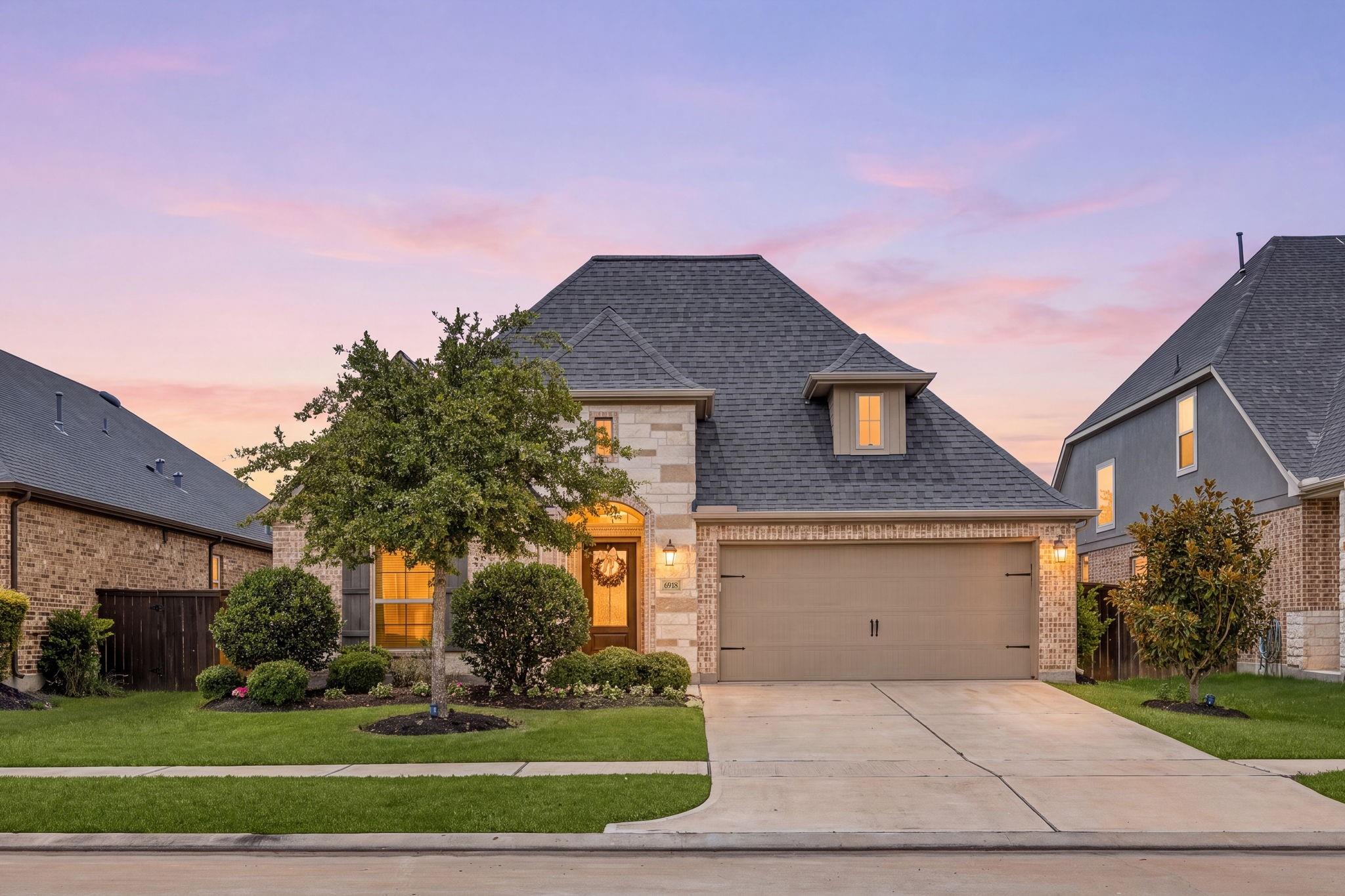 Home not selling in Katy turned into a 21-day sale — twilight exterior of the Cane Island listing at 6918 Goldstrum Way