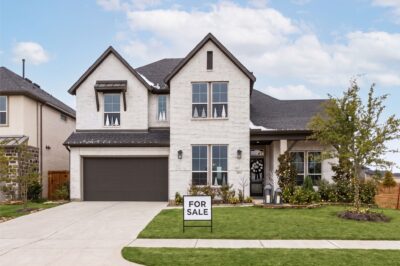 A Katy home decorated tastefully for the holidays with a for-sale sign in the yard.