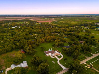 Aerial view of a Fulshear property showing the lot, trees, and outdoor living area]