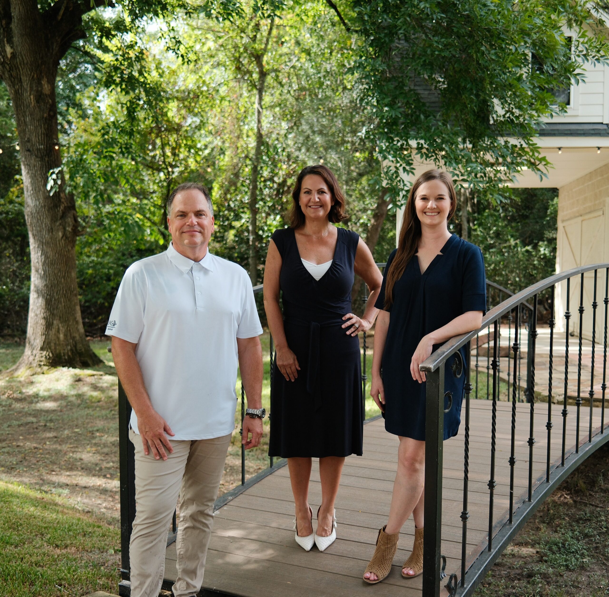 Real estate professionals standing together outdoors near a Katy, Texas home, representing local expertise in the fall 2026 Katy real estate market.
